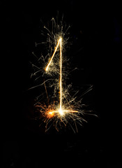 "1" number drawn with bengali sparkles isolated on black background,number from sparkler on black background