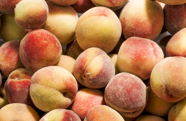 Bunch of fresh ripe peaches as a background