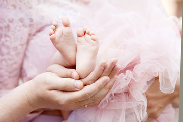 Baby feet in parents hands closeup.  Happy Family concept. 