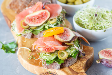 sandwich with fish, rye bread and figs