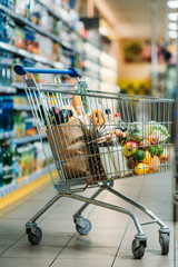 shopping cart with purchases in supermarket © LIGHTFIELD STUDIOS
