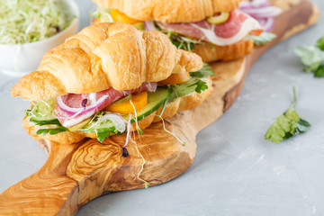 croissant sandwich with ham, olives and vegetable