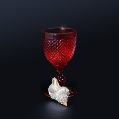 Shell and red crystal glass on a black background