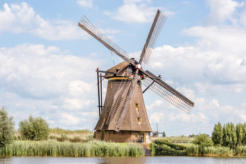 Fototapeta na wymiar Landscape view on the old windmill in Kinderdijk village in Netherlands