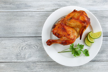 appetizing grilled chicken on white plate