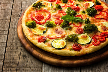 Delicious pizza served on wooden plate 