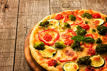 Delicious pizza served on wooden plate 