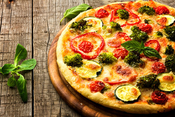 Delicious pizza served on wooden plate 