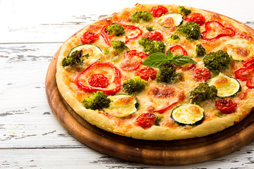 Delicious pizza served on wooden plate 