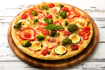 Delicious pizza served on wooden plate 