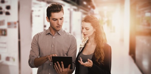 Composite image of concentrated business people using a digital