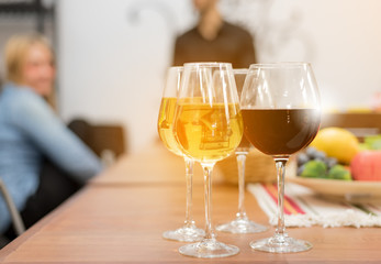 Closed up ,Glasses of red and white wine with fruit on table ,Blurred background,with copyspace
