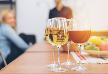 Closed up ,Glasses of red and white wine with fruit on table ,Blurred background,with copyspace,vintage toned