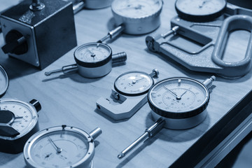The industry measurement instrument in the light blue scene.The various type of dial gauge for...