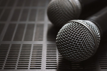 closeup microphone on the volume control with over light and soft-focus in the background