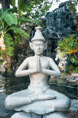 Buddhist sculpture sitting in a garden