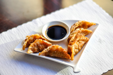 Chicken Pot Stickers, Crispy fried or steamed dumplings with sweet soy sauce.