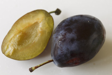Vegan food. Fresh plum, isolated on white background