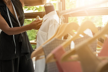 Closed Up hands of seamstress at work with cloth fabric.Tailor working in tailor shop, Tailoring