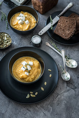 pumpkin soup in black plates 