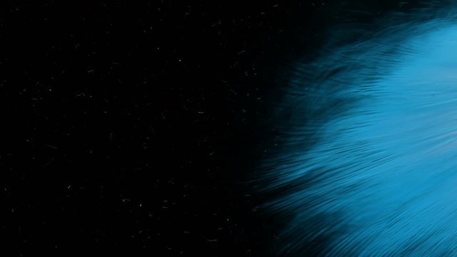 Macro of stylized deep blue ink dispersing in water waves abstract background