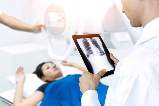 x-Ray or direct radiograph with out film , film-less machine ct scan technology concept. Doctor use tablet for monitoring chest of patient with digital file in smart healthcare hospital.