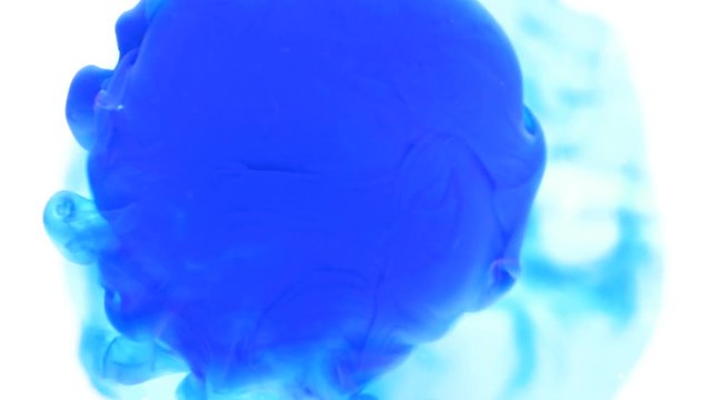 Dropping blue ink paint exploding in water abstract background