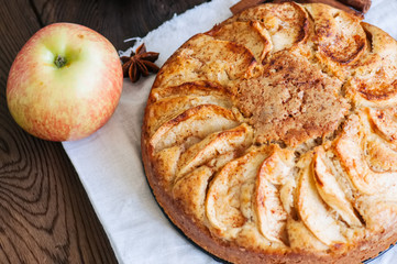 Easy apple tea cake on a wooden background. Homemade baking.