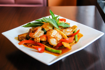 Stir-Fried Spicy Seafood, Stir-fried red curry with shrimp, mussels, scallops, squids, crabmeat, fish balls, bamboo shoots, green beans, basil leaves and eggplant