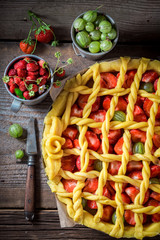 Tasty and aromatic pie with strawberries and gooseberries