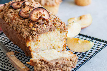 Holland apple crumble bread served on a wire rack on a white stone background. Close up and copy space.