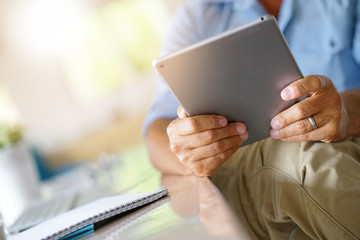 Closeup of digital tablet used by businessman