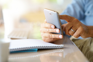 Closeup of male's hands holding smartphone