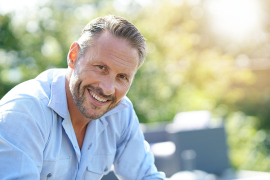 Portrait of smiling mature man relaxing outside