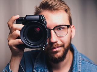 Male photographer with camera in arm