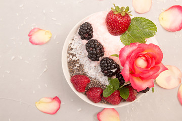 Chia pudding with berries. Overhead dessert with chia, raspberry, blueberry, strawberry and whipped cream. Healthy super food detox concept.