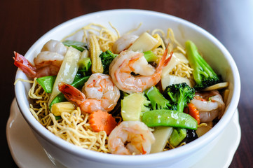 Goey See Me, Crispy egg noodle topped with broccoli, mushroom, bamboo shoot, peapod, carrot, baby corn in delicious gravy sauce