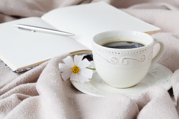 flower on the book, the Cup of black coffee in front of the window in the morning