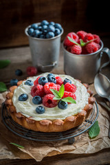 Tasty and aromatic tart with blueberries and raspberries