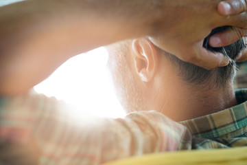 back view of man relaxing in arm chair
