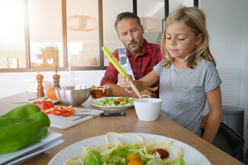 Father and daughter cooking pasta dish together