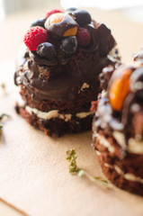 chocolate cake with berries, wooden backdrop