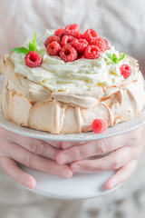 Sweet and creamy Pavlova cake with raspberries and meringue