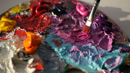 mix red, purple paint on the palette with a brush, HD