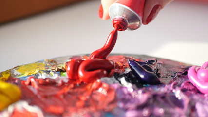 artist squeezes from the tube to the palette purple oily paint , HD.