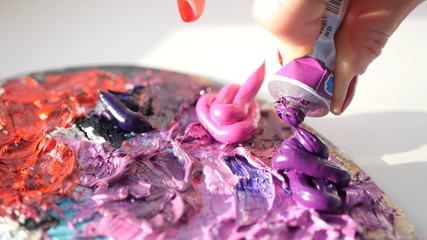 artist squeezes from the tube to the palette purple oily pink paint , HD.
