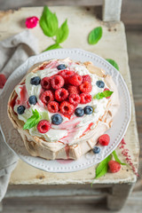 Homemade and rustic Pavlova dessert with raspberries and meringue