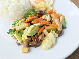 Stir Fried Tofu in Chinese Style, Deep Fried Tofu with Gravy Sauce ,Stir fried tofu with mixed vegetables and fried egg  in white plate on white background. Vegetarian Food, healthy food.
