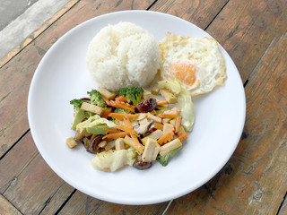 Stir Fried Tofu in Chinese Style, Deep Fried Tofu with Gravy Sauce ,Stir fried tofu with mixed vegetables and fried egg  in white plate on white background. Vegetarian Food, healthy food.