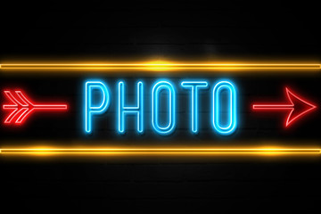 Photo  - fluorescent Neon Sign on brickwall Front view